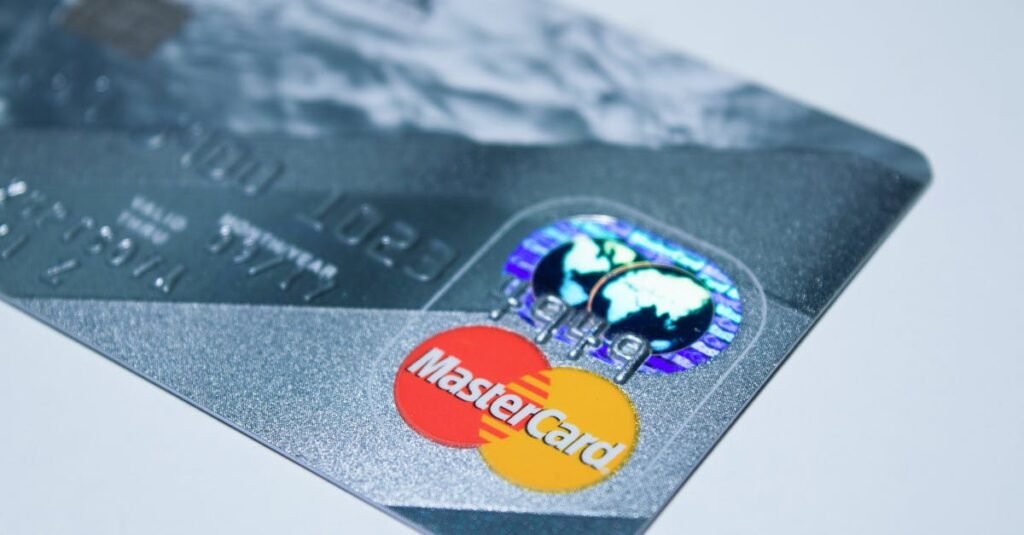 Can You Pay Your Mortgage with a Credit Card? | Here’s the Real Answer (Smart 2026 Guide) Detail shot of a MasterCard credit card, showing the chip and logo.