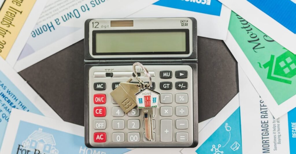 Calculator with keys and real estate documents symbolizes home buying finances.